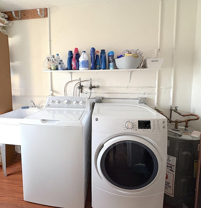 washroom with wood-type flooring and washing machine and dryer