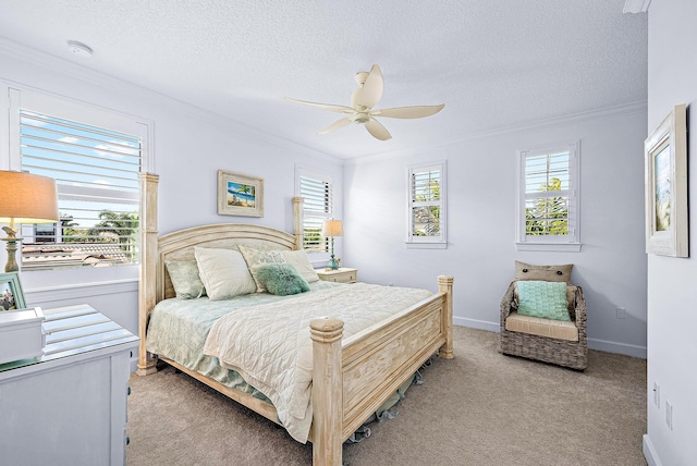 carpeted bedroom featuring ceiling fan, ornamental molding, multiple windows, and a textured ceiling