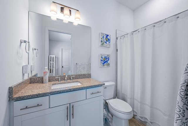 bathroom featuring toilet and vanity