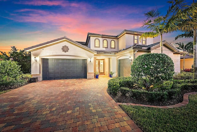 mediterranean / spanish house featuring a garage