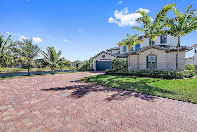 view of front of property featuring a front yard and a garage