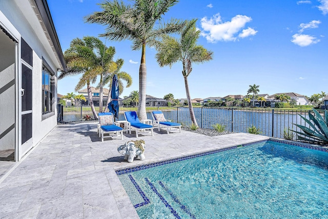 view of swimming pool with a patio area and a water view