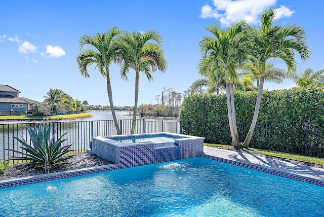 view of pool with pool water feature, an in ground hot tub, and a water view