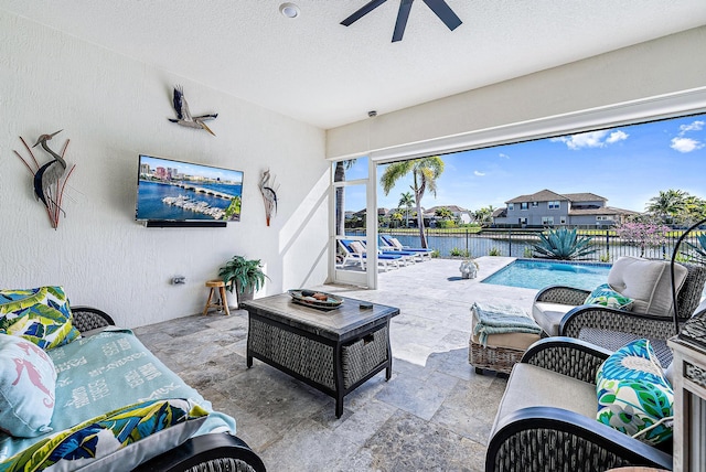 view of patio featuring a fenced in pool, ceiling fan, and outdoor lounge area