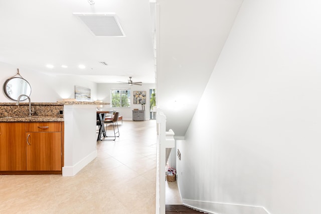 interior space featuring ceiling fan and sink