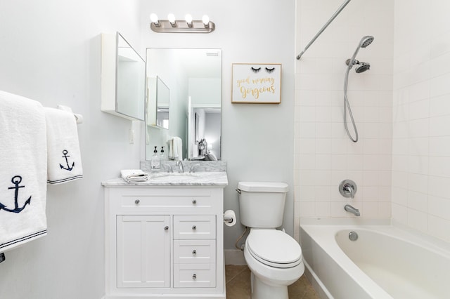 full bathroom featuring tile patterned flooring, vanity, tiled shower / bath combo, and toilet