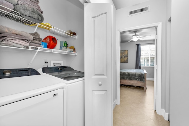 clothes washing area featuring washing machine and clothes dryer, ceiling fan, and light tile patterned floors