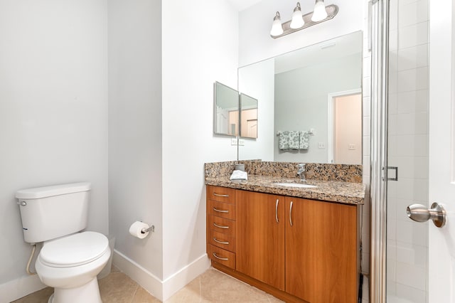 bathroom featuring tile patterned floors, vanity, toilet, and an enclosed shower