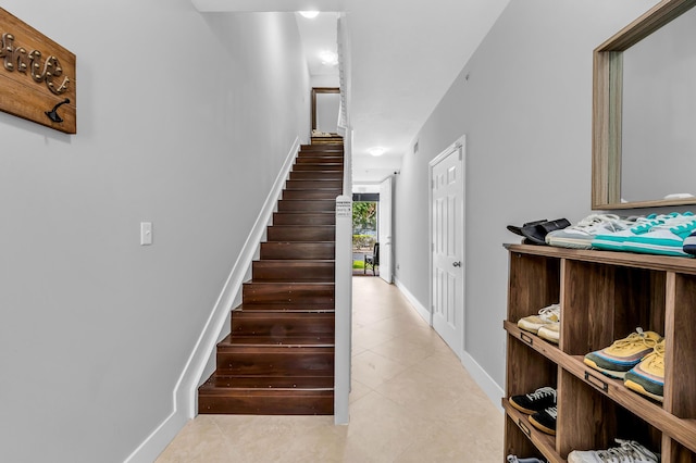 stairway featuring tile patterned flooring