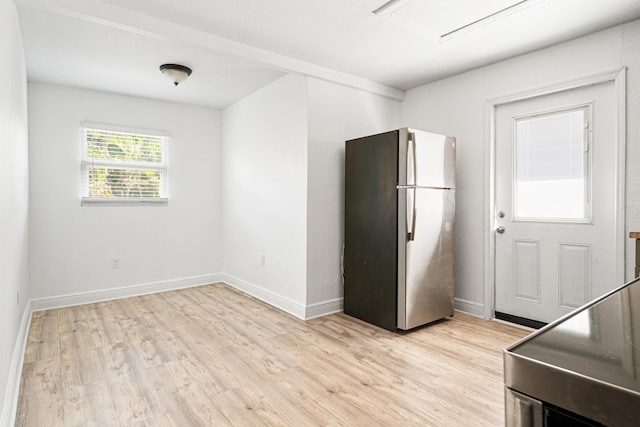 kitchen with stainless steel fridge, light hardwood / wood-style flooring, and range