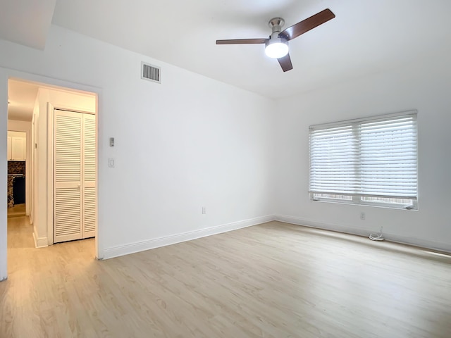 empty room featuring ceiling fan and light hardwood / wood-style flooring