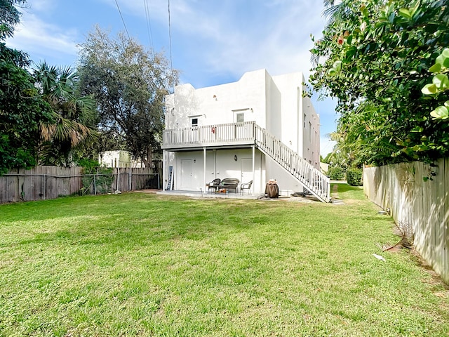 rear view of house with a patio and a yard