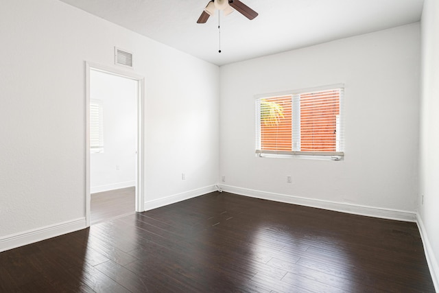 empty room featuring dark hardwood / wood-style flooring and ceiling fan