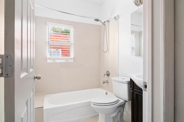 full bathroom featuring toilet, vanity, and tiled shower / bath combo