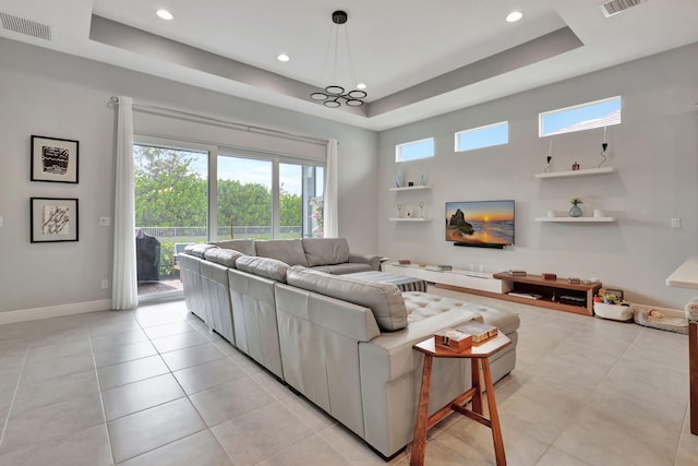 tiled living room with a tray ceiling