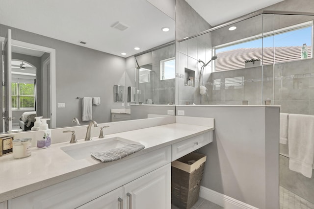 bathroom with vanity and a tile shower