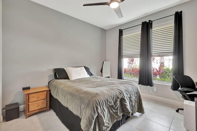 tiled bedroom featuring ceiling fan