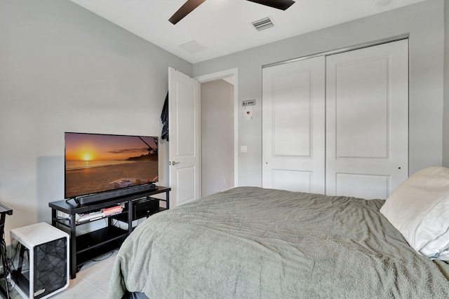 bedroom with ceiling fan, a closet, and light tile patterned flooring