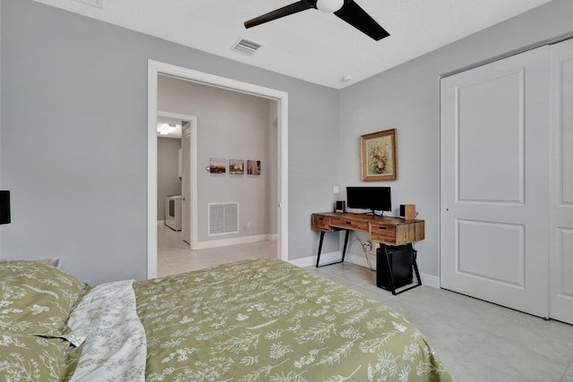 bedroom featuring ceiling fan, light tile patterned floors, and a closet