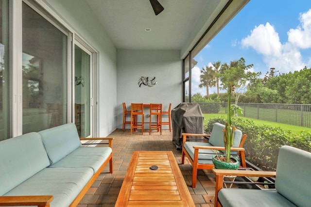 sunroom featuring ceiling fan