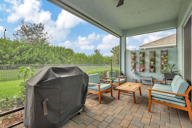 sunroom featuring ceiling fan