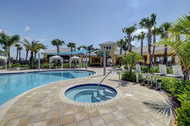 view of swimming pool with a patio area and a community hot tub