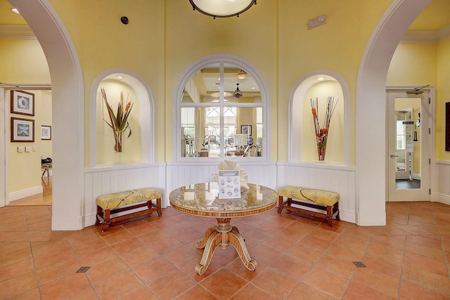 sitting room featuring ceiling fan, tile patterned floors, and ornamental molding