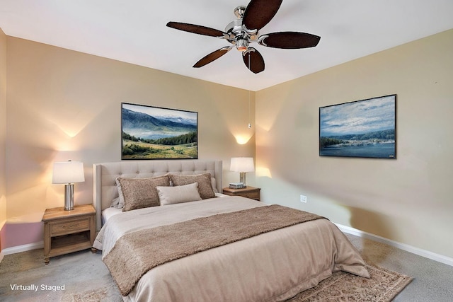 bedroom with light carpet, ceiling fan, and baseboards