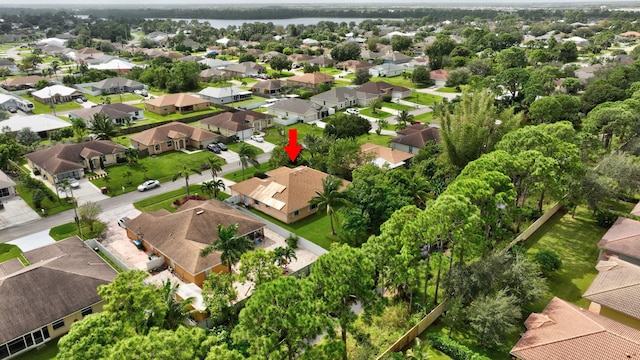 drone / aerial view featuring a residential view and a water view