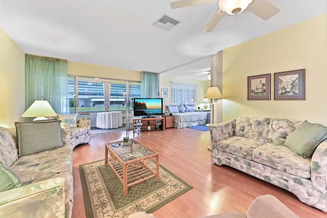 living room with ceiling fan and hardwood / wood-style floors