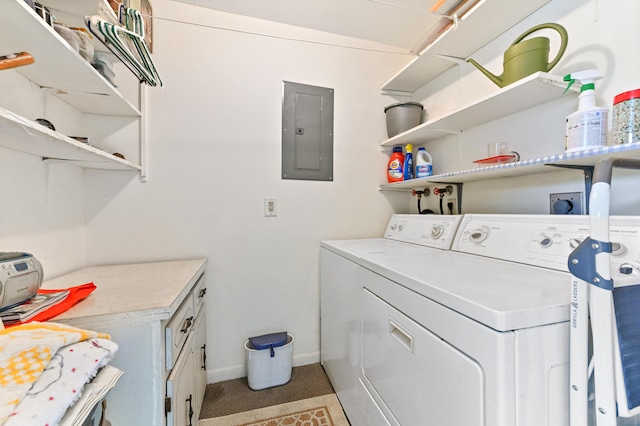 washroom featuring electric panel, separate washer and dryer, and cabinets