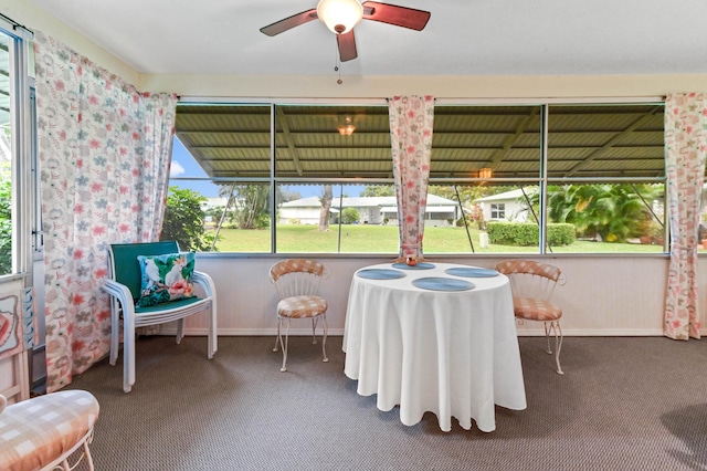 sunroom featuring ceiling fan