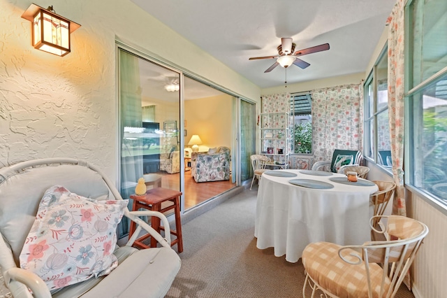 sunroom featuring ceiling fan