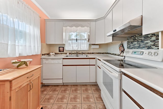 kitchen with ornamental molding, sink, white appliances, and white cabinetry