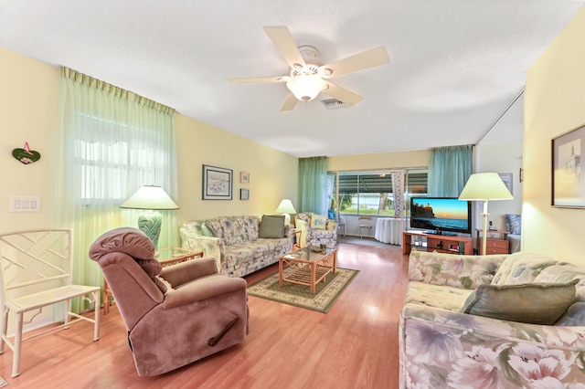 living room featuring ceiling fan and wood-type flooring