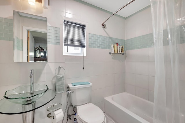 full bathroom featuring sink, shower / tub combo with curtain, tile walls, and toilet