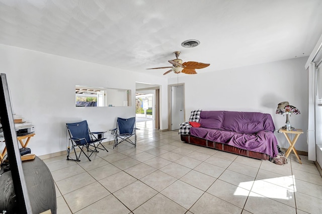 living room with ceiling fan and light tile patterned flooring