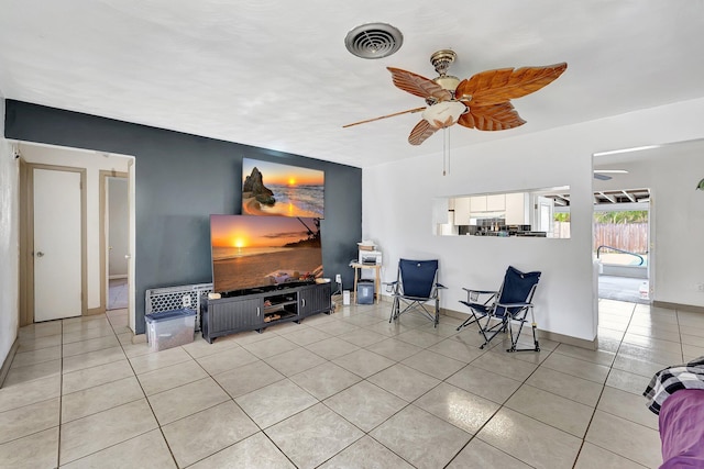 tiled living room with ceiling fan