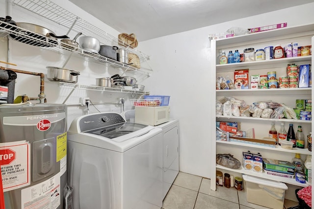 laundry area featuring light tile patterned floors, independent washer and dryer, and water heater