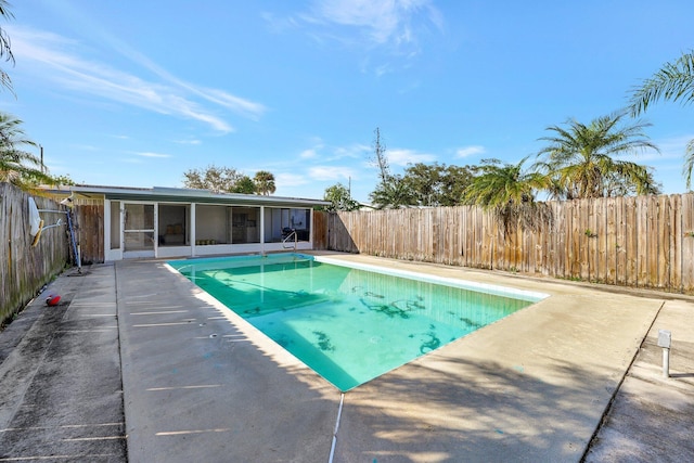 view of pool featuring a sunroom and a patio area