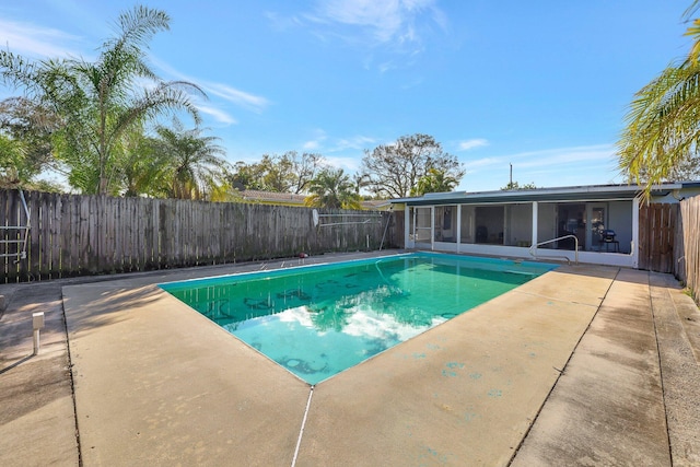 view of pool featuring a sunroom and a patio