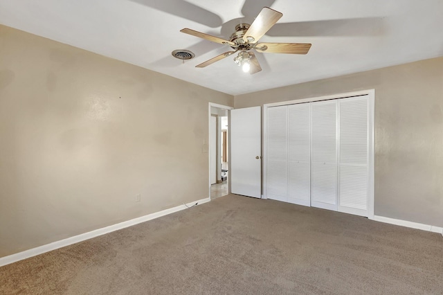 unfurnished bedroom with ceiling fan, carpet floors, and a closet