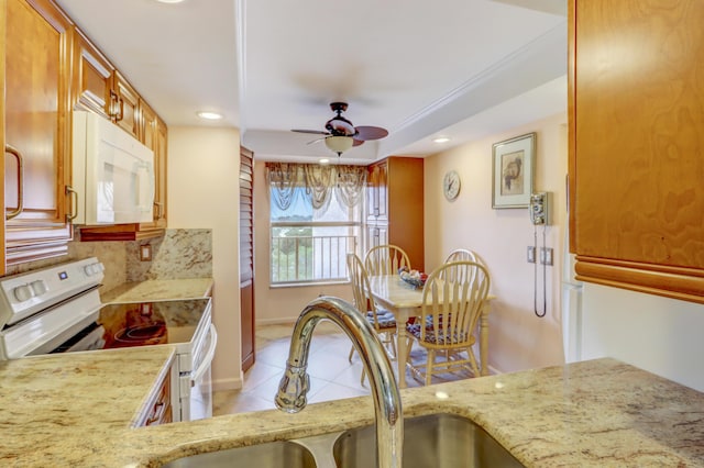 kitchen featuring white appliances, sink, ceiling fan, decorative backsplash, and light tile patterned floors