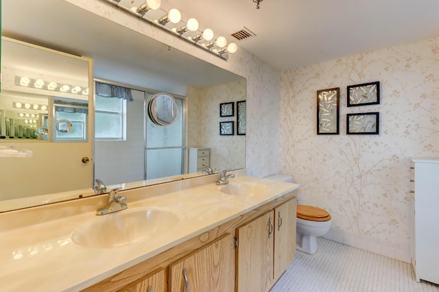 bathroom with tile patterned floors, vanity, and toilet