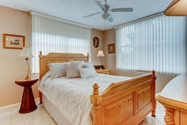 bedroom with ceiling fan and a textured ceiling