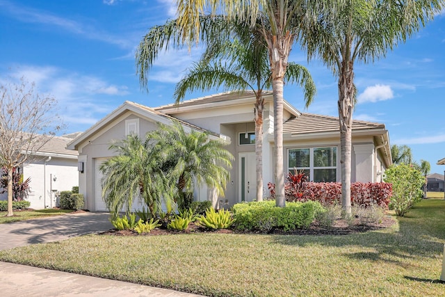 view of front of home featuring a garage and a front lawn