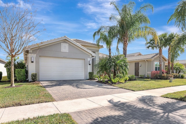 single story home with a garage and a front lawn