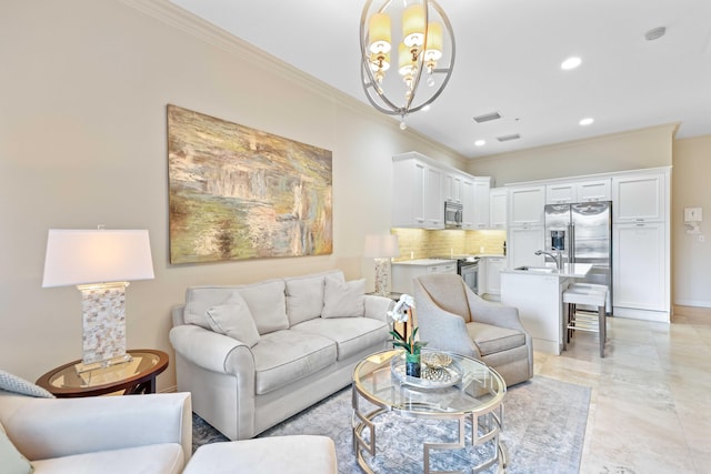 living room with sink, crown molding, and an inviting chandelier