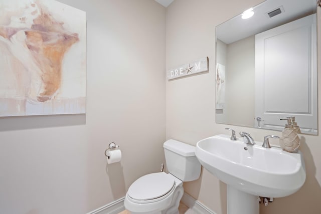 bathroom featuring toilet and sink