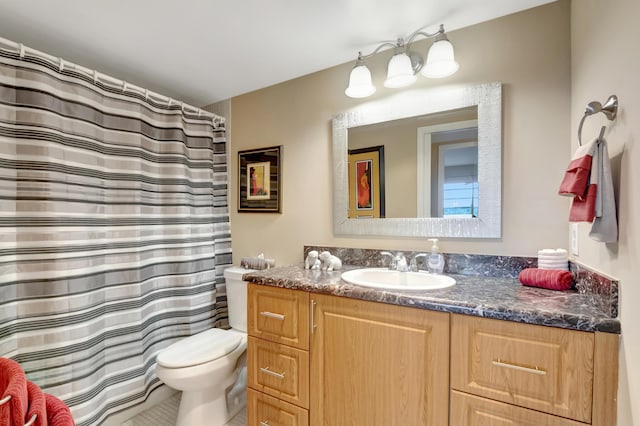 bathroom featuring tile patterned flooring, vanity, and toilet